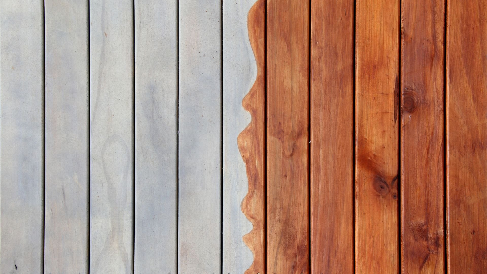 Wooden planks in gray and brown tones with organic wavy dividing line