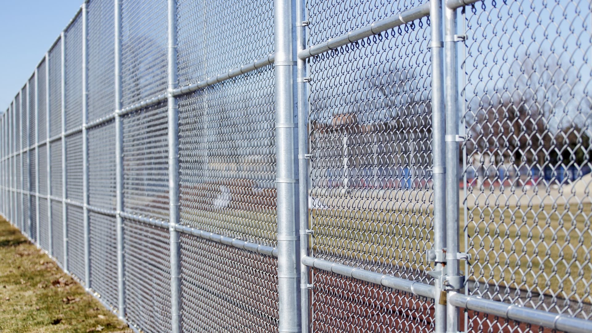 High metal chain-link fence with multiple layers and support poles